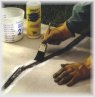 Apply at thin layer of bonding adhesive to the entire repair area using a paint brush. The bonding adhesive helps keep the repair material from loosening or popping out of the crack.